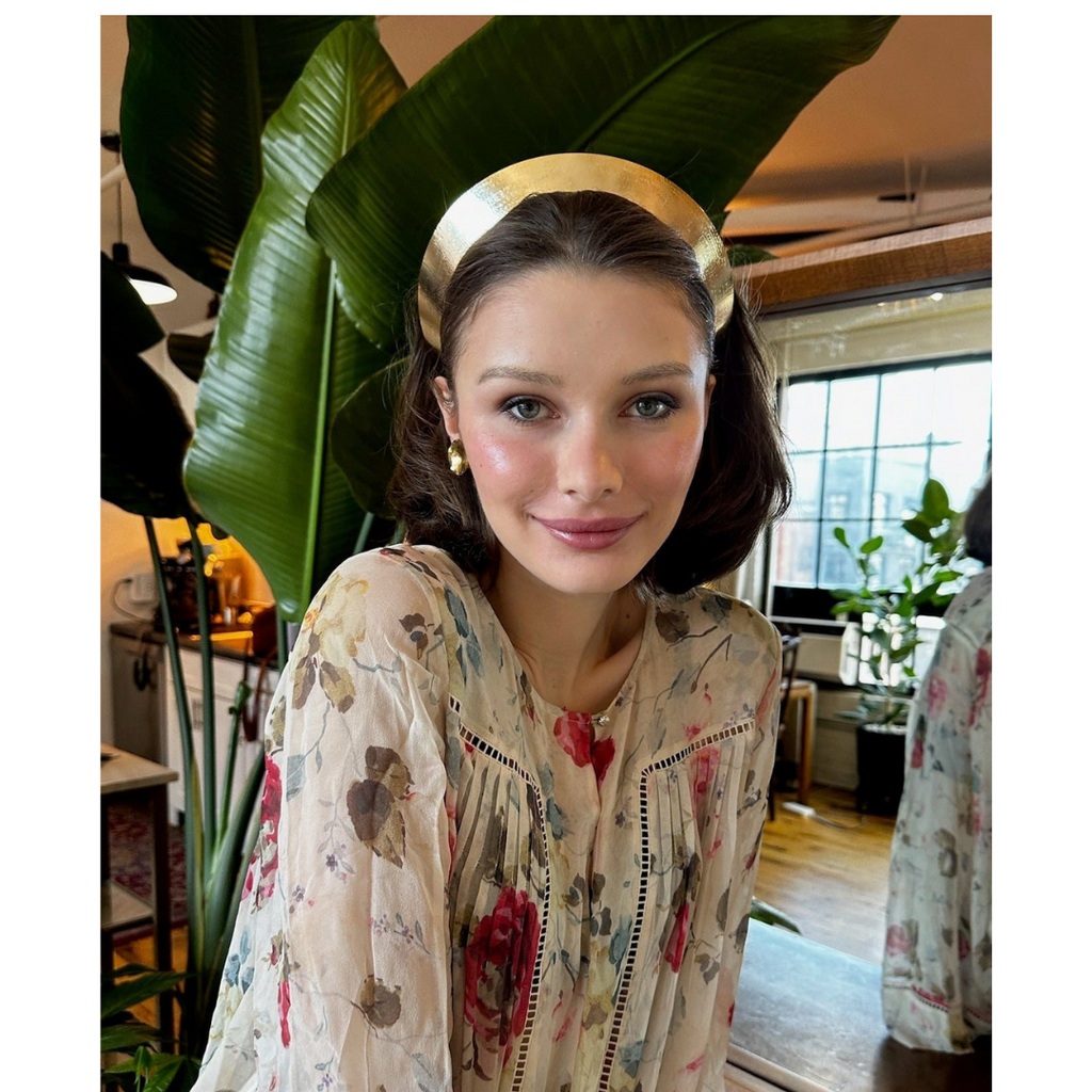 woman wearing an Extra wide spun gold textured headband with high-shine finish