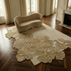 Hibiscus Designer luxury rug with gold floral cut out pattern on a textured beige background made from wool and bamboo silk
