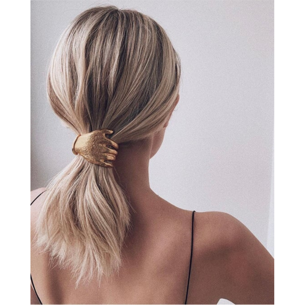 woman wearing Le Hand Barrette by epona valley – surrealist-inspired luxury designer hair accessory made in NYC